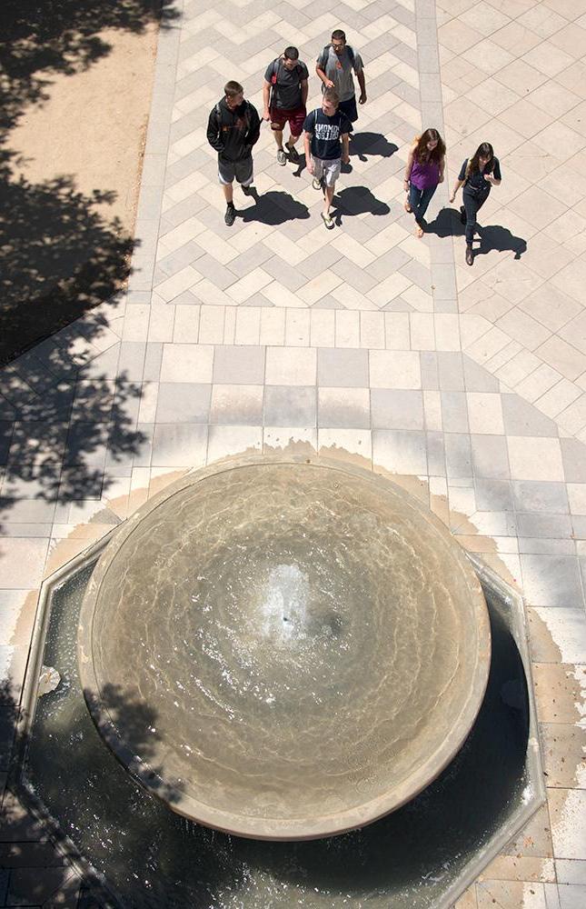 Students walking near Bixby Fountain on North Campus at Pomona College.